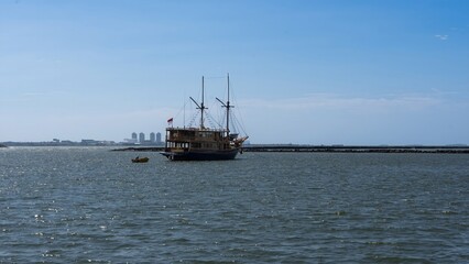 Traditional Indonesian Phinisi Schooner on a Calm Blue Sea with Copy Space
