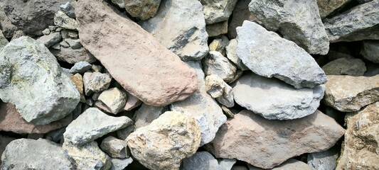 Pile of rocks and stones for construction, natural texture background.