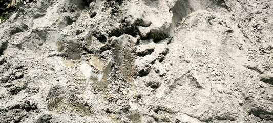 Pile of wet construction sand, abstract background texture.