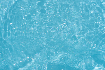 Blue water with ripples on the surface. Defocus blurred transparent blue colored clear calm water...