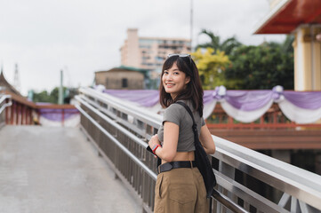 Happy solo southeast asian woman teenager blogger world travel. local cultural experience and...
