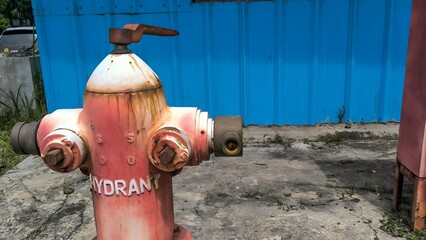 Close-up of an old fire hydrant and water valve for emergency firefighting.