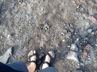 Hiker's First Person View Standing on Volcanic Soil and Rock
