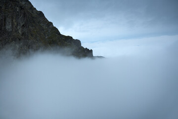 Mountain peaks above the clouds. Landscape of the High Tatras.
