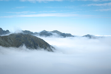 Mountain peaks above the clouds. Landscape of the High Tatras.
