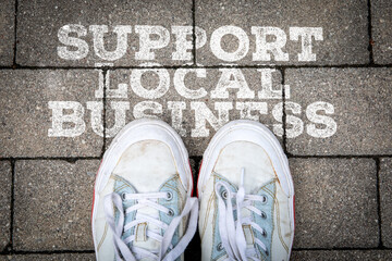 Support Local Business Message with Worn Sneakers on Urban Pavement Street View