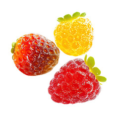 Three colorful gummy fruit candies, strawberry, raspberry, and lemon.  Close-up view