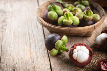 Whole mangosteen and cut into pieces Place in basket on wooden floor
