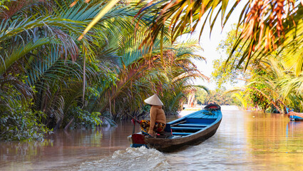 Fisherman is fishing in Mekong river in the morning - People boating in the delta of Mekong river,...