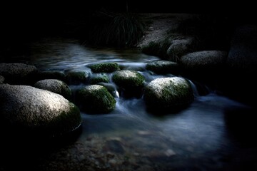 Fototapeta premium Night creek, mossy stones, flowing water