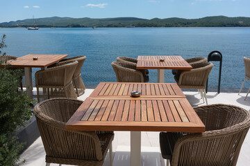 Wooden cafe tables with sea view
