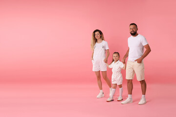 Happy family on pink background. Space for text