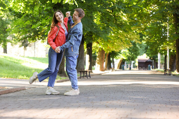 Obraz premium Lovely couple spending time together in park, space for text