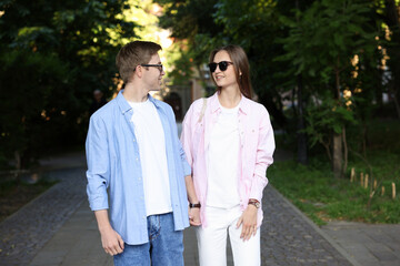 Lovely couple walking together on city street