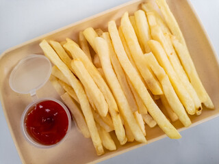 French Fries or Potato Chips with dipping ketchup on white dish