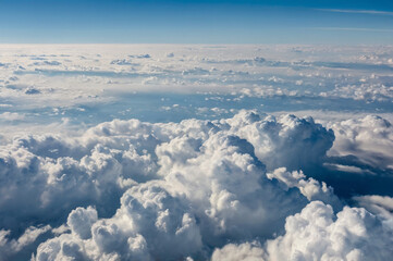 Fototapeta premium Vast expanse of white and blue clouds under a clear sky aerial view