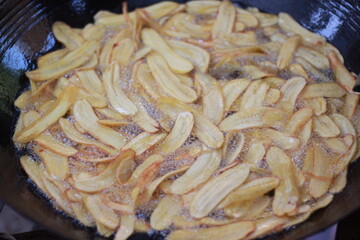 Bananas being fried in a pan
