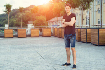 Young man in denim shorts. Summer style.