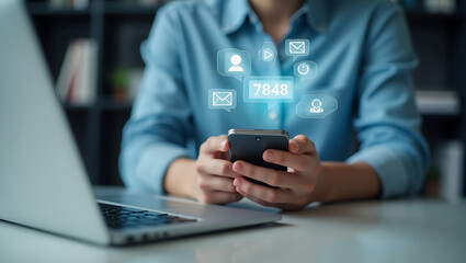 Woman using smartphone with social media notifications and laptop on desk