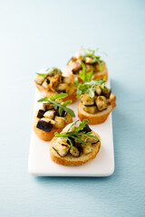 Crostini with eggplant and arugula