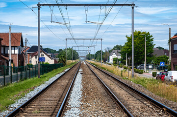 Empty double railway tracks, perspective view in Lede, East Flanders, Belgium