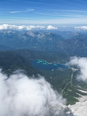 Drone view of the Zugspitze summit, Germany’s highest peak in the Bavarian Alps. The aerial photo captures the mountain station, observation platforms, rugged cliffs, and the breathtaking alpine