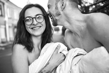 A loving couple shares a laugh together in this intimate, black and white portrait.