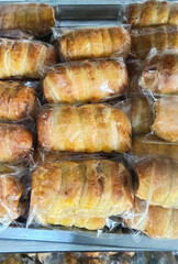 Golden Baked Pastries Individually Wrapped in Plastic