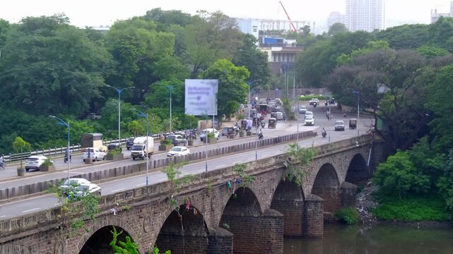 16 July 2025, Pune, Maharashtra, India, Pune City Traffic, Vehicle moves along the Pune metro rail road near Sangam Bridge.