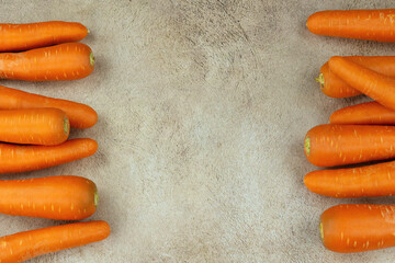 Carrot and text space. Textured background for text and carrot-shaped vegetables.
