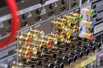 Rear panel of a high-quality AV receiver with multimedia connections for connecting speakers, analog and digital signals. 