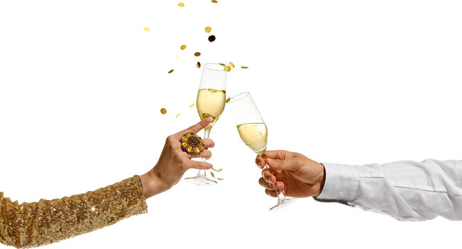 Male and female hands clinking champagne flutes with sparkling wine as golden confetti falls in air on transparent background. Concept of celebration, luxury, festive moment.