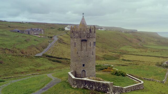 Aerial dolly of Doonagore Castle on an overcast day. Doolin, Ireland