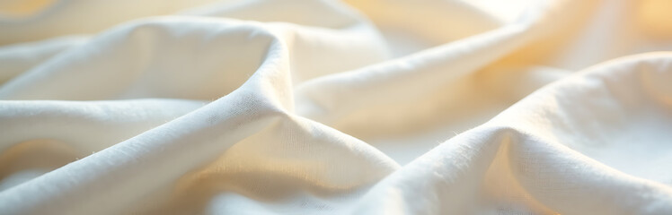 luxurious white linen fabric subtle gold undertones intricately textured filling frame soft warm glow shallow depth