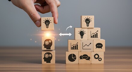 Hand arranging wooden blocks with icons representing ideas and business strategy concepts