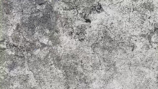 Closeup of cracked weathered gray concrete or stone surface, perfect for backgrounds, textures, construction, or architecturethemed designs and projects.