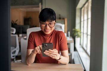 Businesswoman Using Smartphone in Modern Office Setting