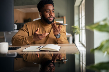 Man Speaking on Smartphone While Seated at a Desk