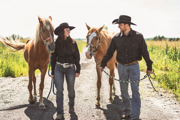 couple boyboy and girl, stands next to her horse in summer season