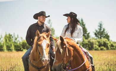 couple boyboy and girl, stands next to her horse in summer season