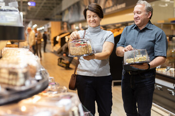 husband and wife choose cake in store for festive dinner