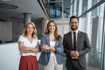 Portrait of confident business team smiling in modern office