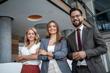 Business team smiling with confidence in modern office building