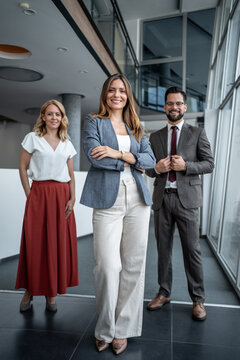Business team smiling with confidence in modern office building
