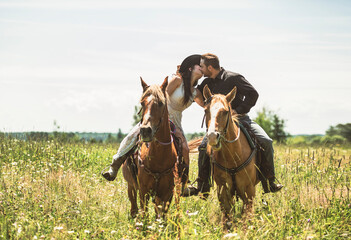 couple boyboy and girl, stands next to her horse in summer season