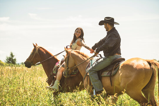 couple boyboy and girl, stands next to her horse in summer season
