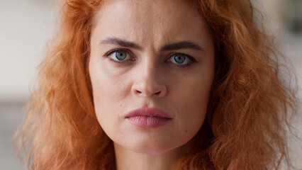 Close up female face serious angry negative bad mood stressed offended disappointed frustrated...