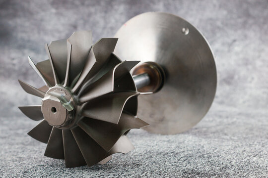 Close up Turbocharger rotor Shaft, impeller Shaft wheel turbocharger, turbine Shaft turbocharger on isolated background.