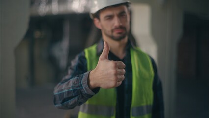 Satisfied Caucasian guy demonstrating thumb up in construction workman supervisor approve builder...