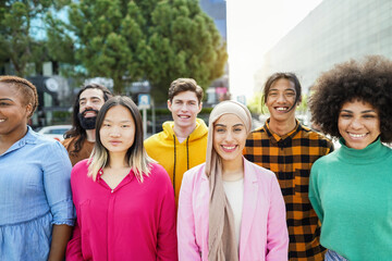 Group of happy multiracial people smiling on camera with city in background - Diversity, multiethnic and people lifestyle concept - Main focus on arabian and asian women faces